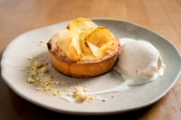 Homemade apple pie with a golden, crispy crust, topped with thin slices of caramelized apple. The perfectly baked crust is